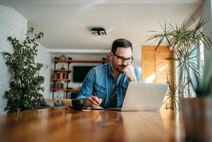 A man in front  of his laptop