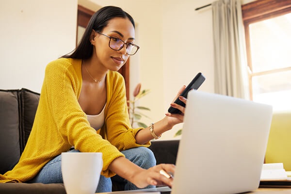 Using laptop and phone on a desk