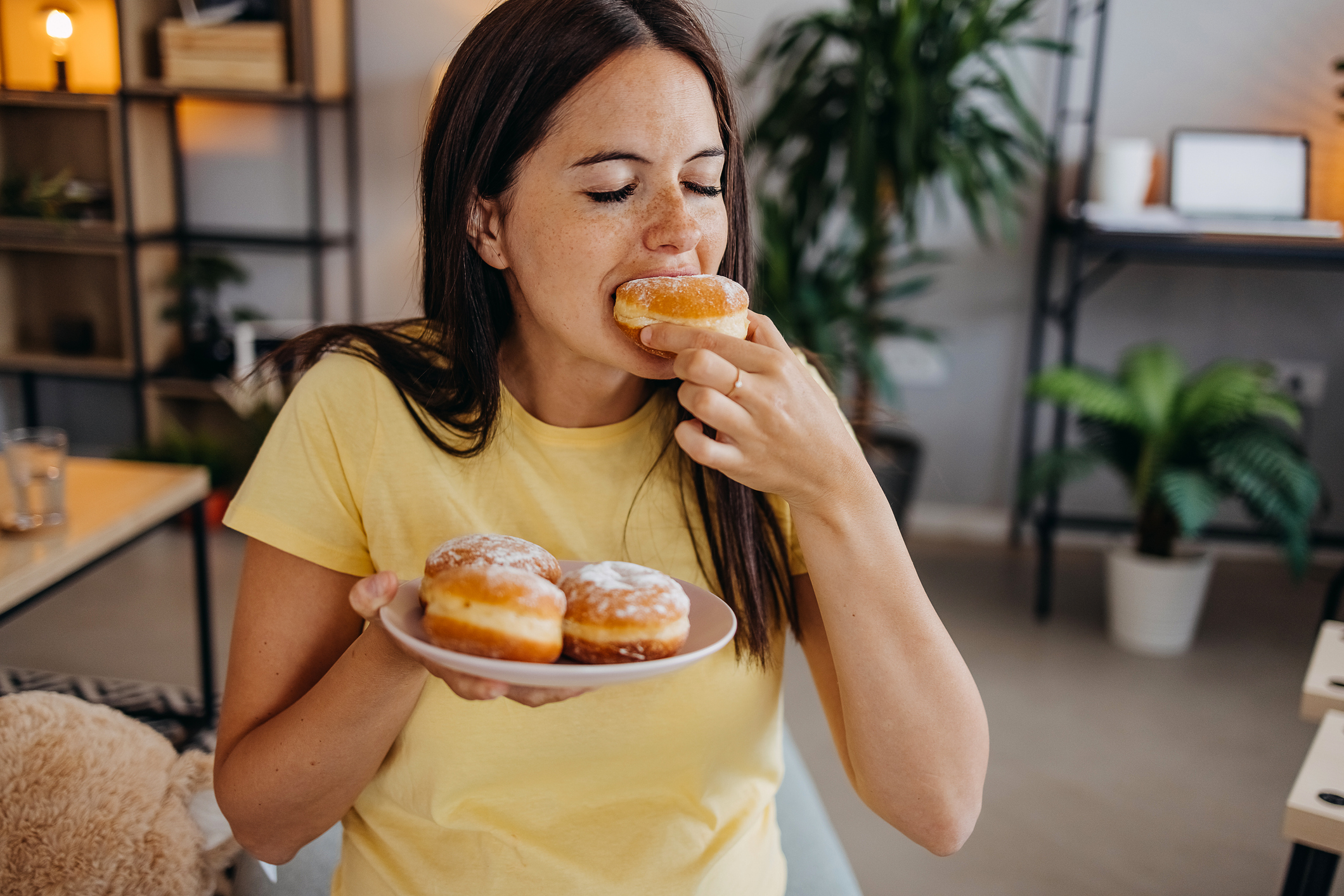 A lady eating donuts